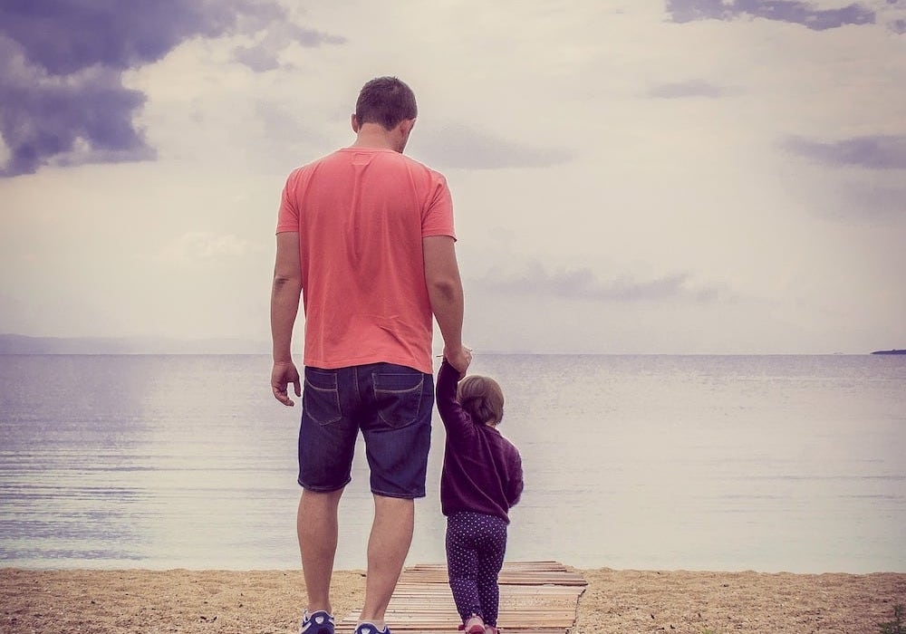 father with child on the beach