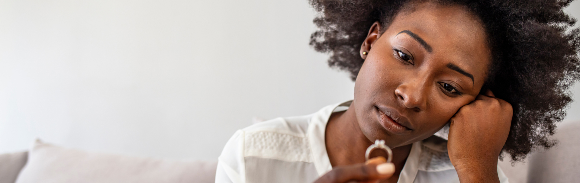 Unhappy woman holding wedding ring close up upset girl crying depressed with divorce - Somerset County Divorce Lawyers concept image